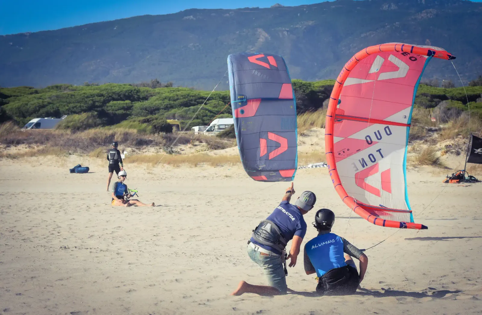 Two Matos Tarifa students learning kite control on the sand at Tarifa