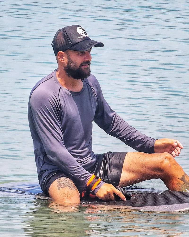 Instructor sitting on a board in the water