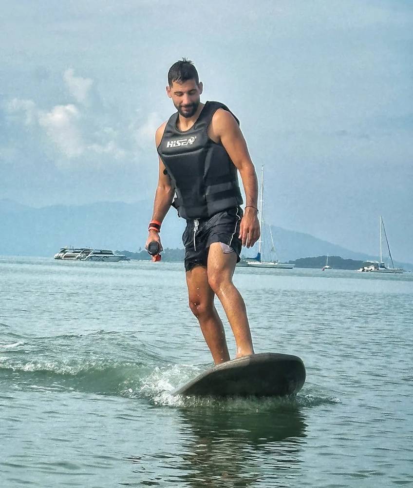 Jetsurf rider in a vest standing on the board