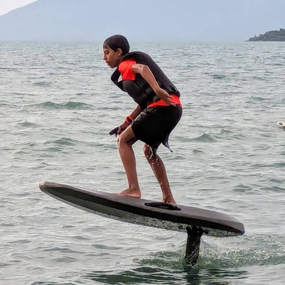 Kid in a life vest riding the e-foil