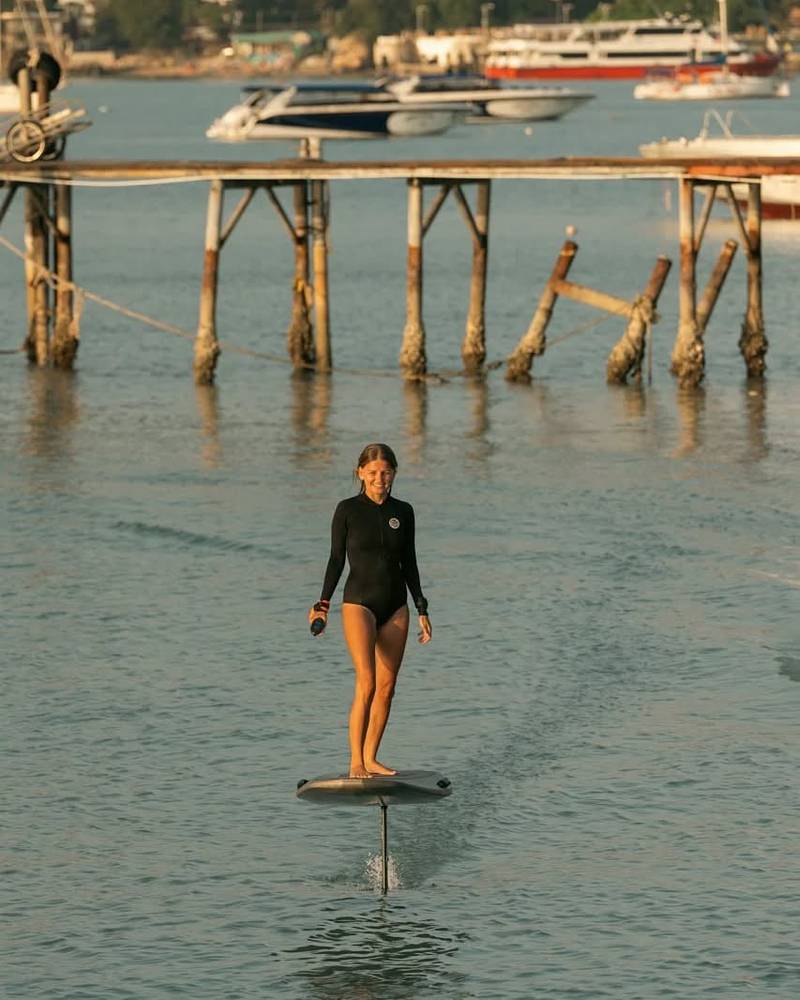 Rider gliding past an old wooden pier
