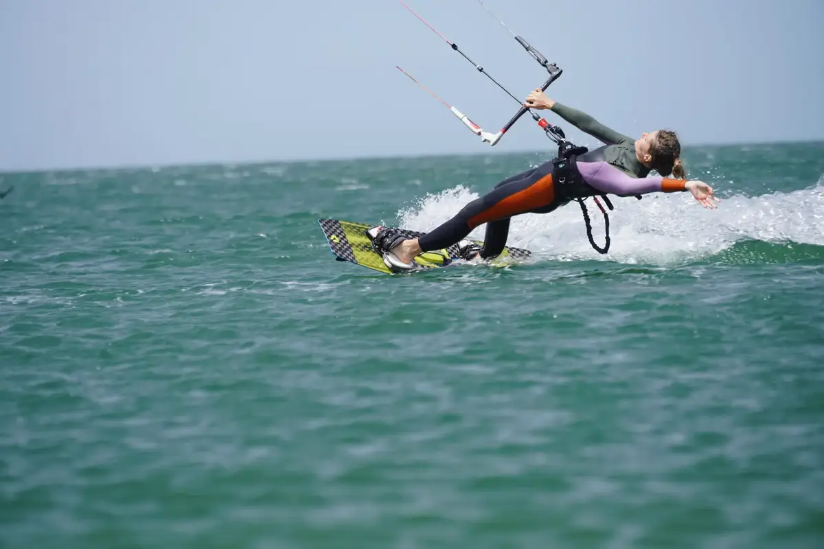 A kitesurfer riding through the water of the Dakhla lagoon at the end of the day
