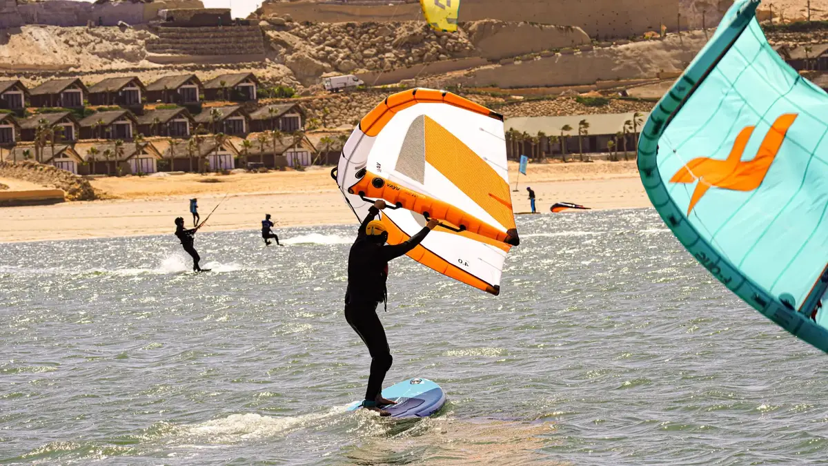 A wing foiler holding the wing up on the Dakhla lagoon