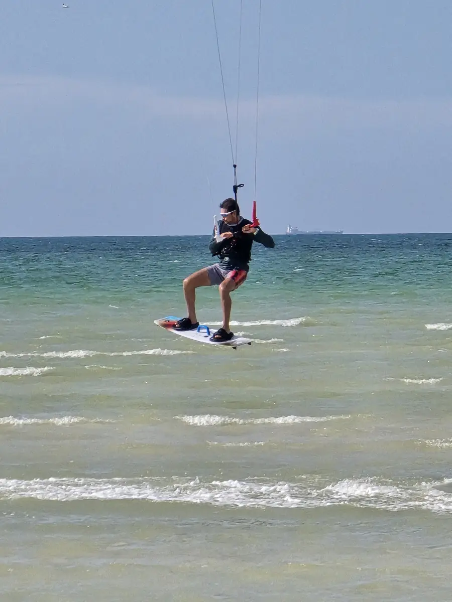 Kitesurfer jumping above the water in the bay of Progreso