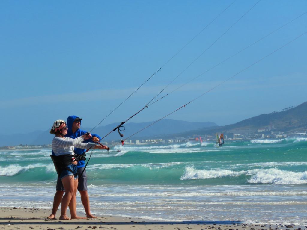 Instructor standing behind a student holding the bar in the shallow water
